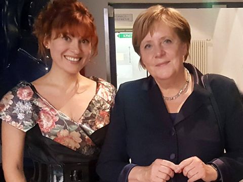 Pianist Yuliya Drogalova and Angela Merkel, Chancellor of the Federal Republic of Germany, stand side by side